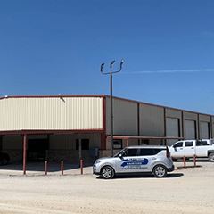 a white building with cars parked nearby