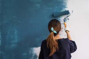 a person painting an interior bedroom